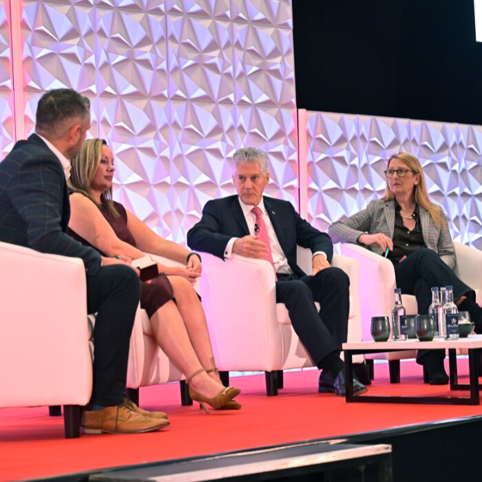 Panel discussion on stage at Wales Tech Week 2025, ICC Wales