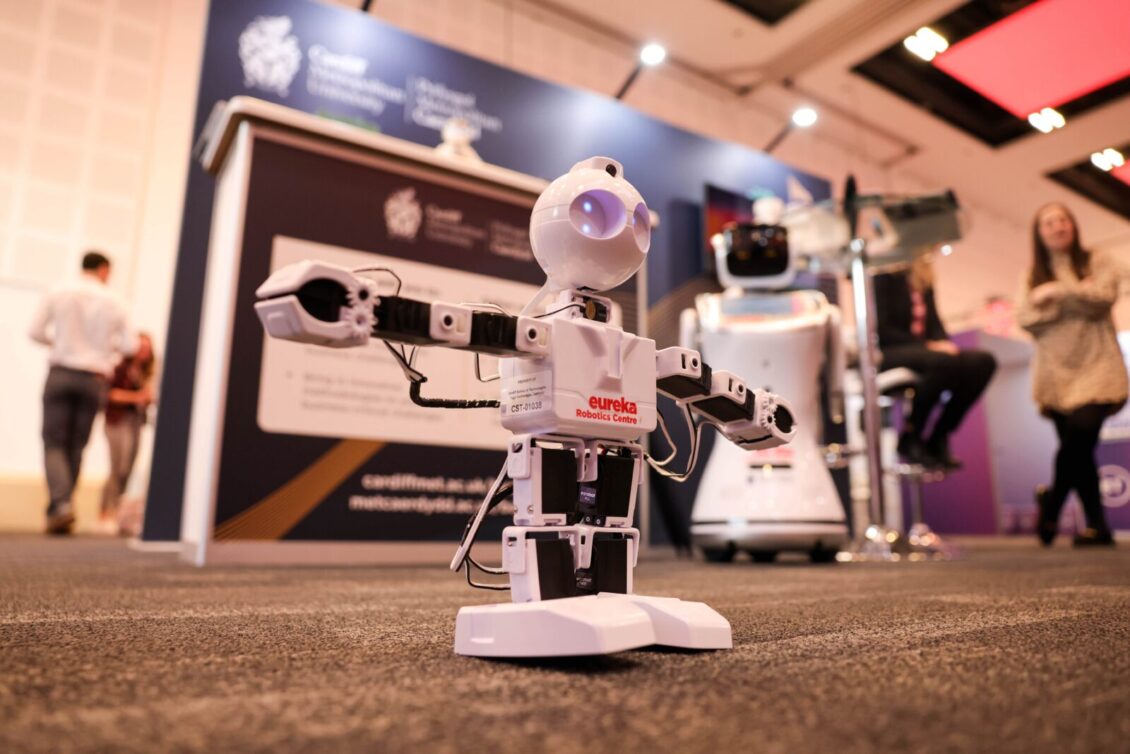 Small humanoid robot on the exhibition floor at Wales Tech Week