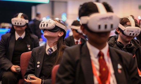 Students in school uniform wearing VR headsets at Wales Tech Week 2025